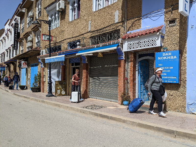 Group of my Anyone Can Travel tourists walking with their luggage